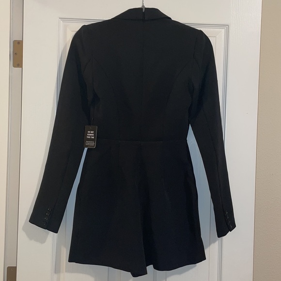 Black Romper suit. Never worn it just tried it on. 95% Polyester 5% Spandex. - Picture 2 of 3